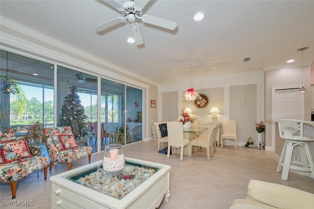 tiled living room featuring ceiling fan and crown molding