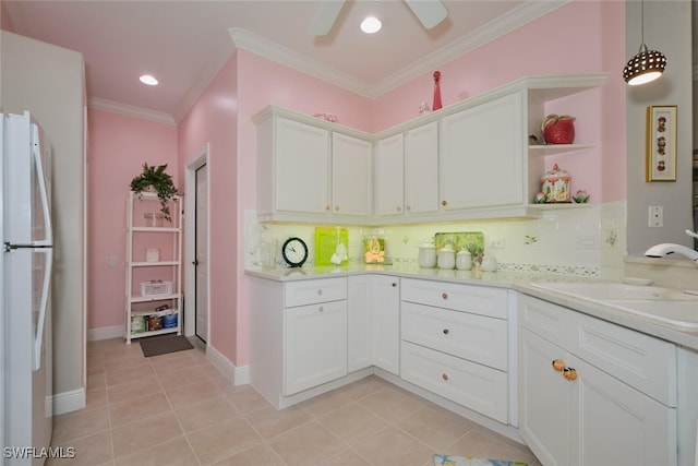 kitchen featuring ceiling fan, white fridge, tasteful backsplash, white cabinets, and light tile patterned floors