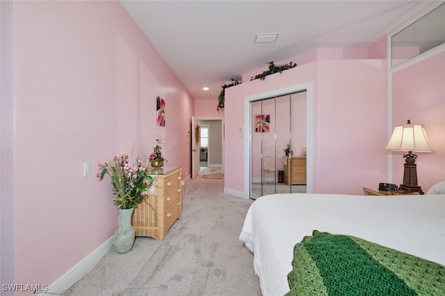 bedroom with a closet and light carpet