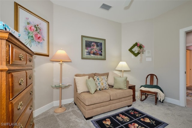 living area featuring light carpet