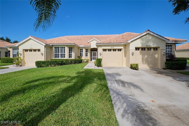 view of front of home featuring a garage and a front lawn