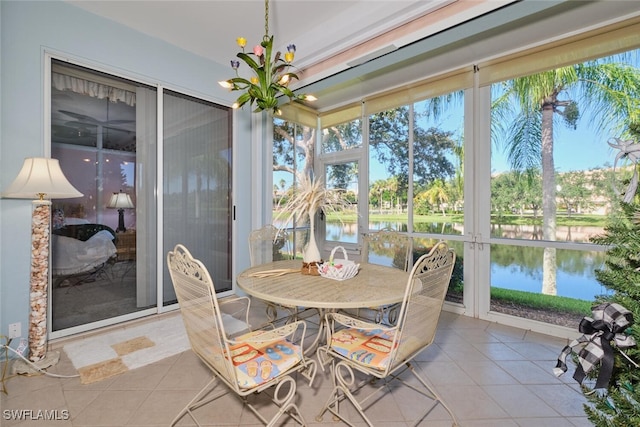 sunroom / solarium featuring a water view