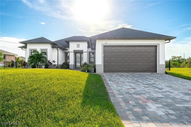 view of front of home featuring a front yard and a garage