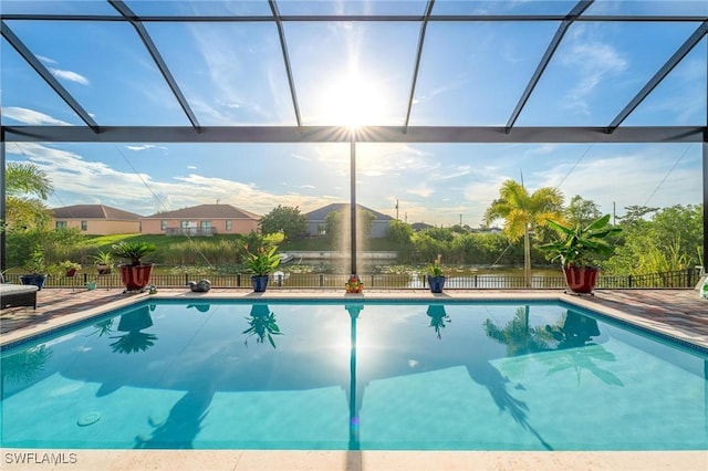 view of swimming pool with a patio area and a lanai