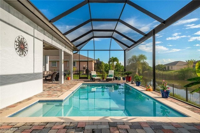 view of pool with a patio and glass enclosure