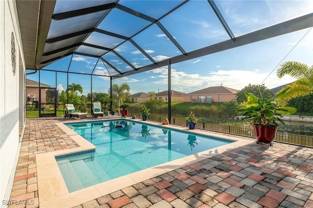 view of swimming pool with a patio and a lanai