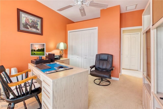 carpeted home office featuring ceiling fan