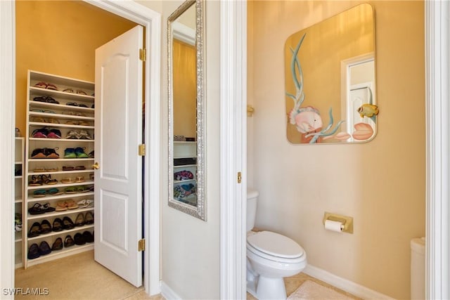 bathroom with tile patterned flooring and toilet