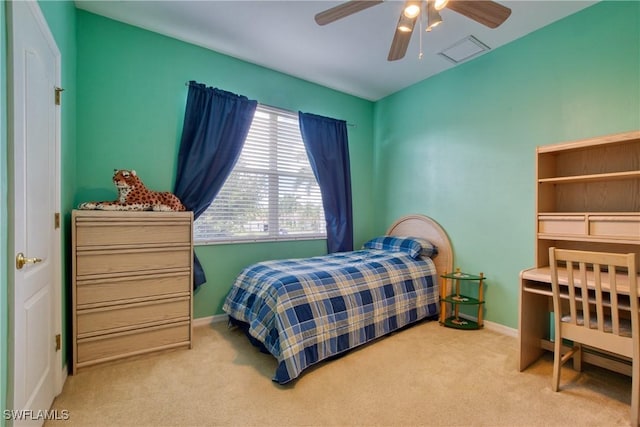 bedroom with ceiling fan and light carpet