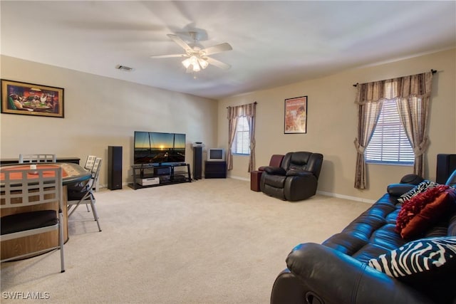 carpeted living room with ceiling fan