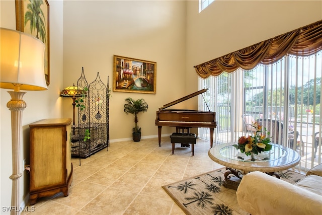 sitting room with a towering ceiling