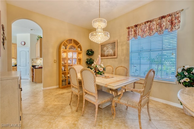 dining room featuring light tile patterned floors and a notable chandelier