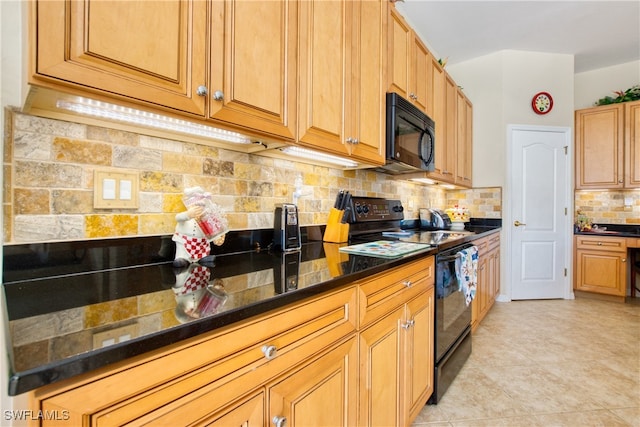 kitchen with black appliances, light tile patterned floors, dark stone counters, and tasteful backsplash