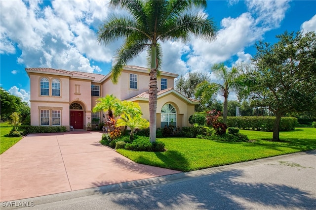 mediterranean / spanish-style house featuring a front yard