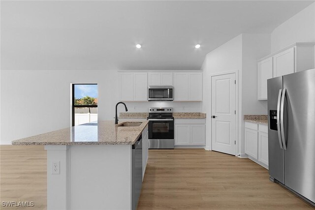 1310 Bush St W, Immokalee, FL 34142 - kitchen featuring stainless steel appliances, a sink, light wood-type flooring, recessed lighting, and an island with sink