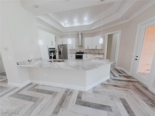 kitchen featuring white cabinetry, stainless steel fridge with ice dispenser, hanging light fixtures, and a raised ceiling