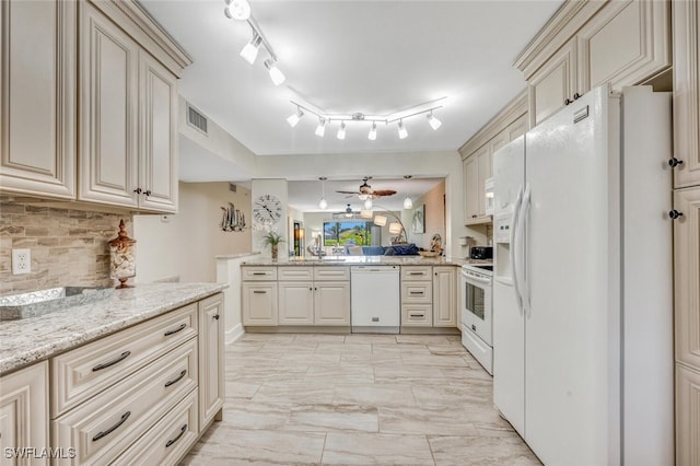 kitchen with decorative backsplash, cream cabinets, ceiling fan, and white appliances