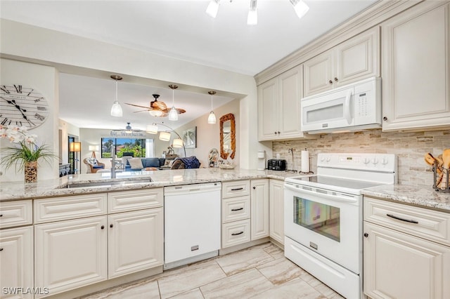 kitchen with decorative backsplash, kitchen peninsula, sink, white appliances, and ceiling fan