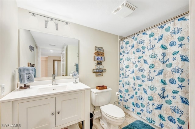 bathroom with vanity, hardwood / wood-style floors, curtained shower, and toilet