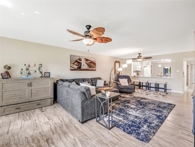 living room with light wood-type flooring and ceiling fan