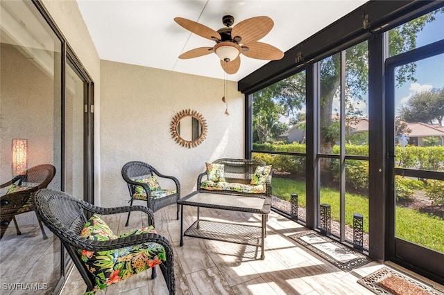 sunroom / solarium featuring ceiling fan