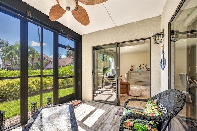 sunroom featuring a wealth of natural light and ceiling fan