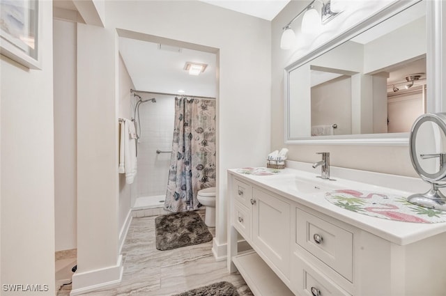 bathroom with vanity, toilet, and curtained shower