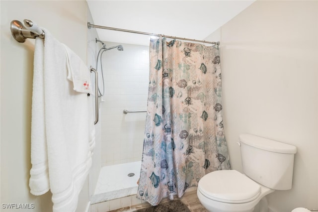 bathroom with toilet and walk in shower