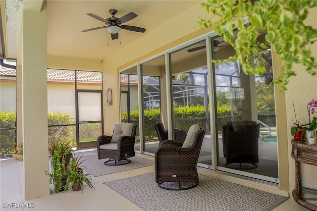 sunroom / solarium featuring ceiling fan