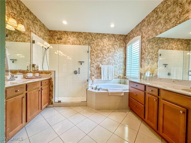 bathroom featuring tile patterned floors, vanity, and shower with separate bathtub