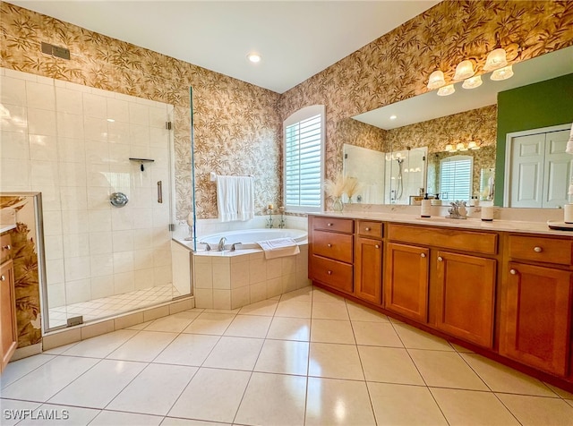 bathroom featuring tile patterned flooring, vanity, and separate shower and tub