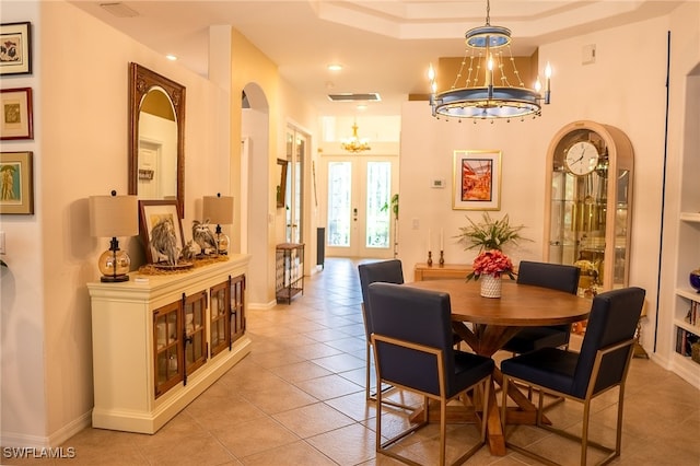 dining room featuring light tile patterned floors, french doors, and a notable chandelier