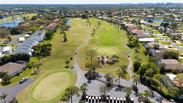 aerial view with view of golf course, a water view, and a residential view