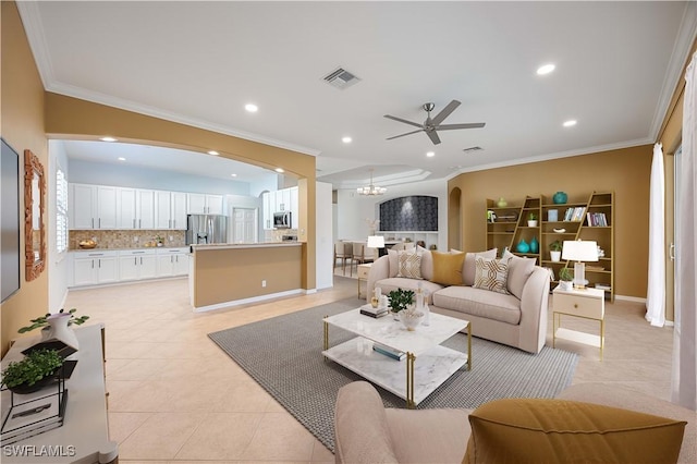 living area featuring arched walkways, ornamental molding, and visible vents