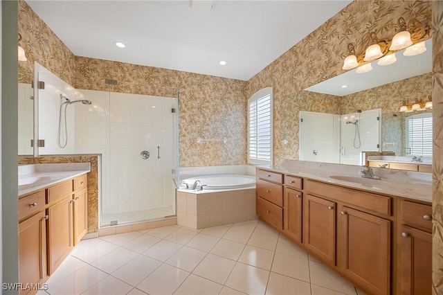 bathroom with wallpapered walls, a garden tub, tile patterned flooring, a shower stall, and a sink