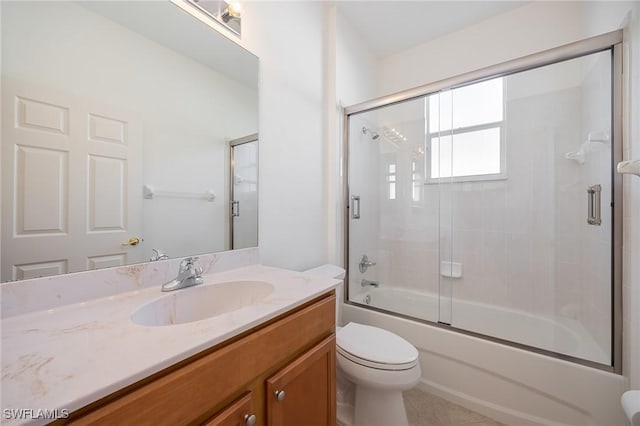 full bath featuring bath / shower combo with glass door, vanity, and toilet