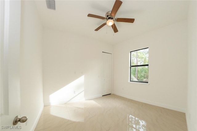 carpeted empty room with ceiling fan