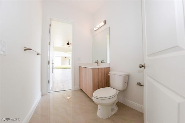 bathroom featuring ceiling fan, tile patterned floors, toilet, and vanity