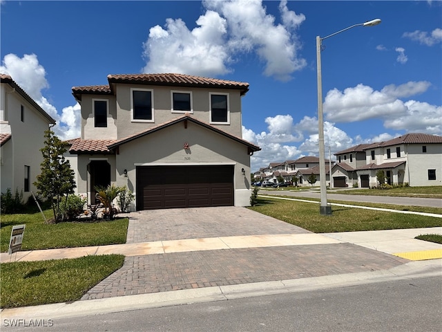 mediterranean / spanish-style house with a front yard and a garage