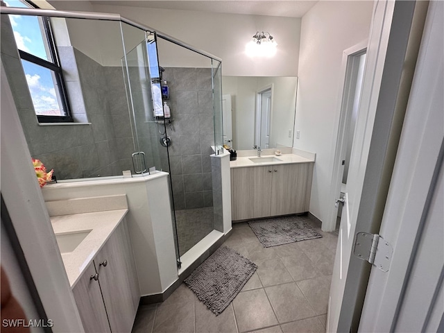 bathroom featuring vanity, an enclosed shower, and tile patterned flooring