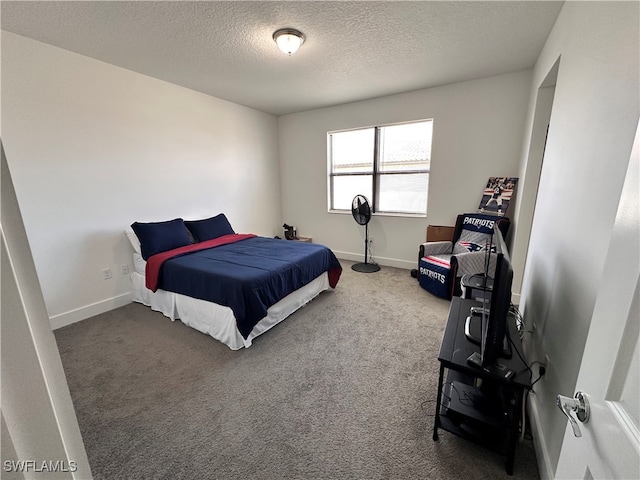 bedroom with carpet and a textured ceiling