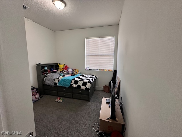 carpeted bedroom with a textured ceiling