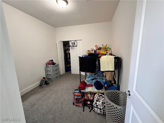 interior space featuring a textured ceiling and carpet