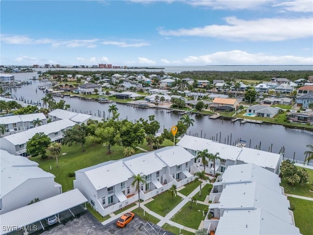 drone / aerial view featuring a water view and a residential view