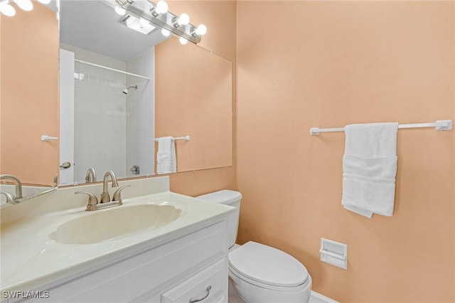 full bathroom with a shower, vanity, and toilet