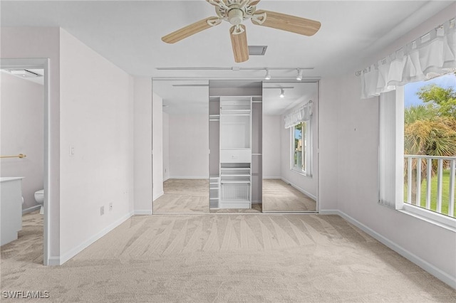 unfurnished bedroom featuring carpet, multiple windows, visible vents, and a closet