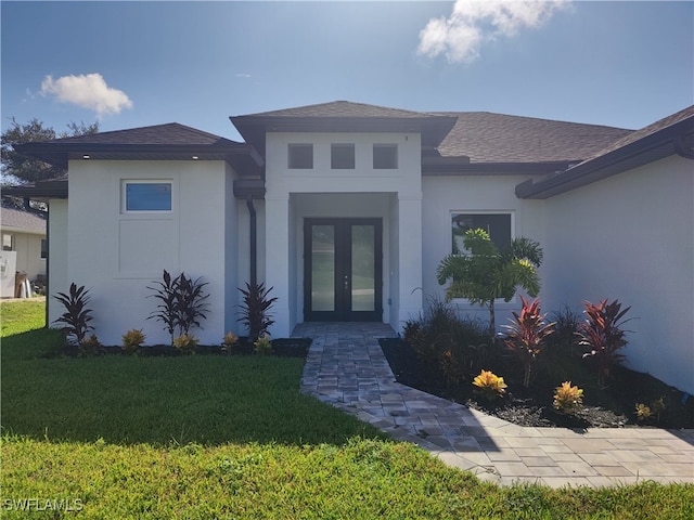 exterior space featuring a front lawn and french doors