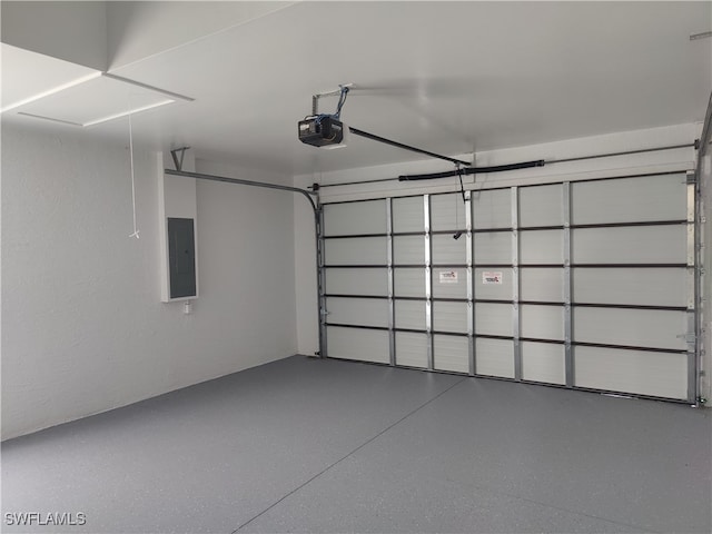 garage with a garage door opener and electric panel