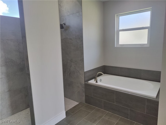 bathroom featuring independent shower and bath and tile patterned flooring