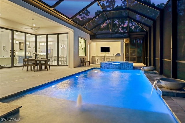 outdoor pool featuring a lanai, ceiling fan, a patio, and an in ground hot tub